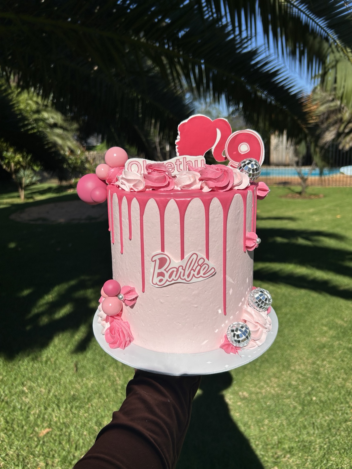 Pink Barbie birthday cake with drip icing and disco balls