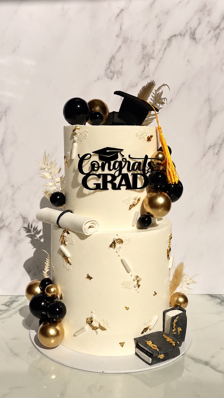 Black, white and gold graduation cake by DNA Bakehouse